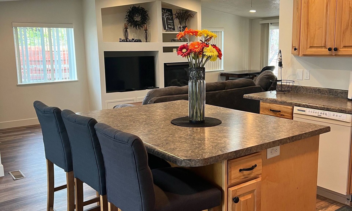 Millcreek House | Open floor plan with a covered patio and fenced yard.